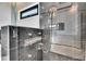 Close up of luxurious black marble shower with rain shower head and modern fixtures at 6538 Simone Shores Cir, Apollo Beach, FL 33572
