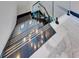 A modern staircase with glass railings and sleek design elements at 6538 Simone Shores Cir, Apollo Beach, FL 33572