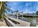 Waterfront view of a new community featuring a dock and boat lift at 6538 Simone Shores Cir, Apollo Beach, FL 33572