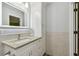 Bathroom vanity featuring granite countertop, modern fixtures, bright lighting, and ample under-sink cabinet space at 1318 Roosevelt Dr, Venice, FL 34293