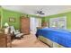 Bright bedroom with natural light, accented by a unique green wall and complimented by hardwood furnishings at 1318 Roosevelt Dr, Venice, FL 34293