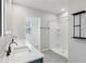 Modern bathroom featuring a double sink vanity, walk-in shower, and neutral color palette, creating a spa-like retreat at 2604 Knight Island Dr, Brandon, FL 33511