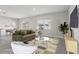 Bright, staged living room featuring a comfortable olive sofa, dining area and lots of natural light at 2604 Knight Island Dr, Brandon, FL 33511