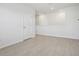 Bright loft with light-colored wood flooring, white walls, and a view into an adjacent room at 2604 Knight Island Dr, Brandon, FL 33511