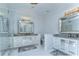 Bright bathroom featuring dual sinks, quartz countertops, mirrored vanity, and a glass shower with luxurious fixtures at 439 Bayview Ne Dr, St Petersburg, FL 33704