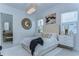 Bright bedroom with modern chandelier, white bedding, and decorative art create a clean and stylish look at 439 Bayview Ne Dr, St Petersburg, FL 33704