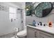 Modern bathroom features a glass-enclosed shower, sleek fixtures, and stylish wallpaper at 5292 Kernwood Ct, Palm Harbor, FL 34685