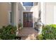 Charming front entrance with brick steps, double doors, and lush landscaping for a welcoming appeal at 5292 Kernwood Ct, Palm Harbor, FL 34685