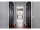 Hallway with dark wood floors leading to a bathroom with a free-standing tub at 5292 Kernwood Ct, Palm Harbor, FL 34685