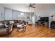 Cozy living room featuring a comfortable leather couch, hardwood floors, and an entertainment center at 5292 Kernwood Ct, Palm Harbor, FL 34685