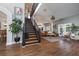 Open floor plan with wood floors, staircase, and plenty of natural light at 5292 Kernwood Ct, Palm Harbor, FL 34685