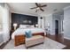 Comfortable main bedroom with paneled accent wall, wood floors and ceiling fan at 5292 Kernwood Ct, Palm Harbor, FL 34685