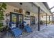 Relaxing outdoor patio with cushioned seating, overhead lighting, and a serene backyard view at 5292 Kernwood Ct, Palm Harbor, FL 34685