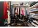 Organized walk-in closet featuring hanging clothes, shoe racks, and shelves for folded items and accessories at 5292 Kernwood Ct, Palm Harbor, FL 34685