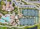 Aerial view of tennis courts, clubhouse, and a pool surrounded by meticulously landscaped grounds and walkways at 5749 Cheech Gln, Bradenton, FL 34211