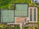 Aerial view of shuffleboard courts and tennis courts, surrounded by landscaping at 5749 Cheech Gln, Bradenton, FL 34211