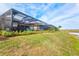 Expansive backyard with lush landscaping, screened lanai, and beautiful pond views at 5749 Cheech Gln, Bradenton, FL 34211