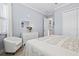 Bedroom featuring natural light, a white dresser with mirror and décor, and a comfortable white chair at 5749 Cheech Gln, Bradenton, FL 34211