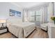 Cozy bedroom with natural light, decorative bedside table with lamp, and a comfortable white chair at 5749 Cheech Gln, Bradenton, FL 34211