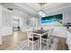 Formal dining room boasts elegant wainscoting, modern chandelier, and a large painting at 5749 Cheech Gln, Bradenton, FL 34211