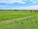 Aerial view of a golf driving range with players and meticulously maintained grounds at 5749 Cheech Gln, Bradenton, FL 34211