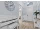 Elegant entryway showcasing a white piano, decorative clock, wainscoting, and doorway to another room at 5749 Cheech Gln, Bradenton, FL 34211