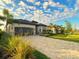 Beautiful home with a paved driveway, attached garage, well-manicured lawn, and lush landscaping, showcasing curb appeal at 5749 Cheech Gln, Bradenton, FL 34211