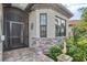 Charming front entrance with stone accents, a screened entry door, and lush landscaping at 5749 Cheech Gln, Bradenton, FL 34211