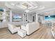 Open-concept living room with a custom entertainment center, stylish decor, and access to the dining area at 5749 Cheech Gln, Bradenton, FL 34211