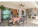 Covered patio featuring an outdoor kitchen with stainless steel grill, sink, and a serene lake view at 5749 Cheech Gln, Bradenton, FL 34211