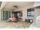 Outdoor patio with seating, granite countertop with grill, and sliding glass doors to the living room at 5749 Cheech Gln, Bradenton, FL 34211