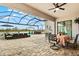 Spacious screened patio overlooking a serene lake with comfortable seating and a hot tub at 5749 Cheech Gln, Bradenton, FL 34211