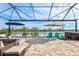This covered patio has ample space for dining, a hot tub, and beautiful lake views at 5749 Cheech Gln, Bradenton, FL 34211