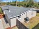 Aerial view showcasing the house with gray shingle roof, fenced yard, and well-maintained landscaping at 6706 Sierra Ter, New Port Richey, FL 34652