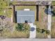 Aerial view showcasing the home's roof, landscaping, driveway, and fully fenced backyard at 6706 Sierra Ter, New Port Richey, FL 34652