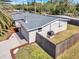 Aerial view of the property highlighting the roof, fenced yard, and surrounding landscape at 6706 Sierra Ter, New Port Richey, FL 34652