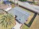 Aerial view of a single-story home featuring a gray roof, fenced yard, and mature landscaping on a sunny day at 6706 Sierra Ter, New Port Richey, FL 34652