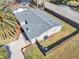Aerial view of the house showing the roof, fenced yard, and landscaping at 6706 Sierra Ter, New Port Richey, FL 34652