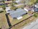 Aerial view of home with fenced backyard, well-maintained lawn, and mature trees in the neighborhood at 6706 Sierra Ter, New Port Richey, FL 34652
