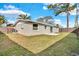 Backyard view featuring a green lawn, patio, and fence providing privacy at 6706 Sierra Ter, New Port Richey, FL 34652