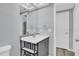Bathroom features a modern vanity with shelves, large mirror, and light gray walls at 6706 Sierra Ter, New Port Richey, FL 34652