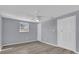 Bedroom featuring a ceiling fan, a closet, a window, light gray walls, and hardwood floors at 6706 Sierra Ter, New Port Richey, FL 34652