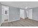 Bedroom with gray walls, wood-look floors, ceiling fan, and an ensuite bathroom and walk-in closets at 6706 Sierra Ter, New Port Richey, FL 34652