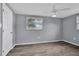 Bedroom with a window, ceiling fan, and closet, showcasing modern finishes at 6706 Sierra Ter, New Port Richey, FL 34652
