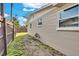 Side exterior of home with a hose reel, windows, neutral paint and privacy fence at 6706 Sierra Ter, New Port Richey, FL 34652