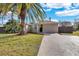 A front exterior shot of the home showcases the well-kept lawn and mature landscaping at 6706 Sierra Ter, New Port Richey, FL 34652