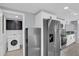 Kitchen with stainless steel appliances, granite countertops, mosaic backsplash and access to laundry room at 6706 Sierra Ter, New Port Richey, FL 34652
