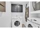 Laundry room with full size washer and dryer and added storage at 6706 Sierra Ter, New Port Richey, FL 34652