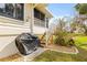 Cozy back porch with stairs and beautiful landscaping, and a grill on the back patio at 1007 Lake Avoca Dr, Tarpon Springs, FL 34689