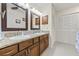 Well lit bathroom featuring double sinks, granite countertops, and modern mirrors at 1007 Lake Avoca Dr, Tarpon Springs, FL 34689